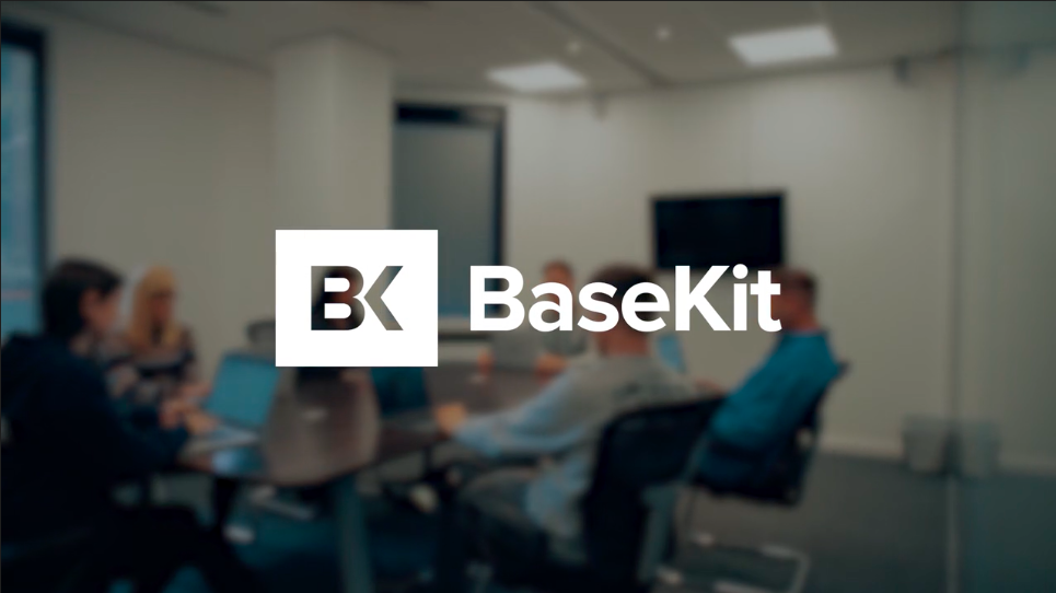 Blurred image of an office background with BaseKit's logo in the middle